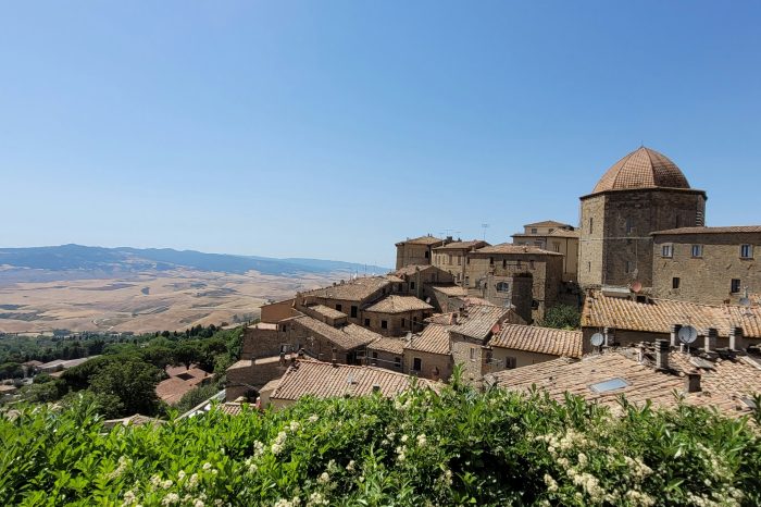 Etruscan stone walls and hilltop rooftops of Volterra, Tuscany, seen on a quiet autumn morning